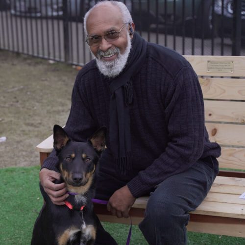 Man with his dog sitting on a bench